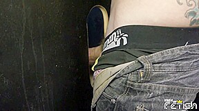 Tattooed man fucks a twink guy with tight ass after getting his big cock sucked trough gloryhole